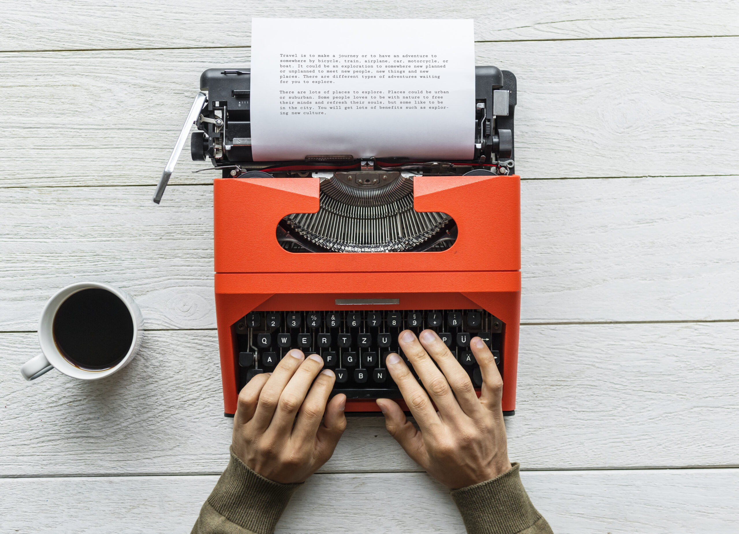 Person writing on a typewriter representing someone copywriting