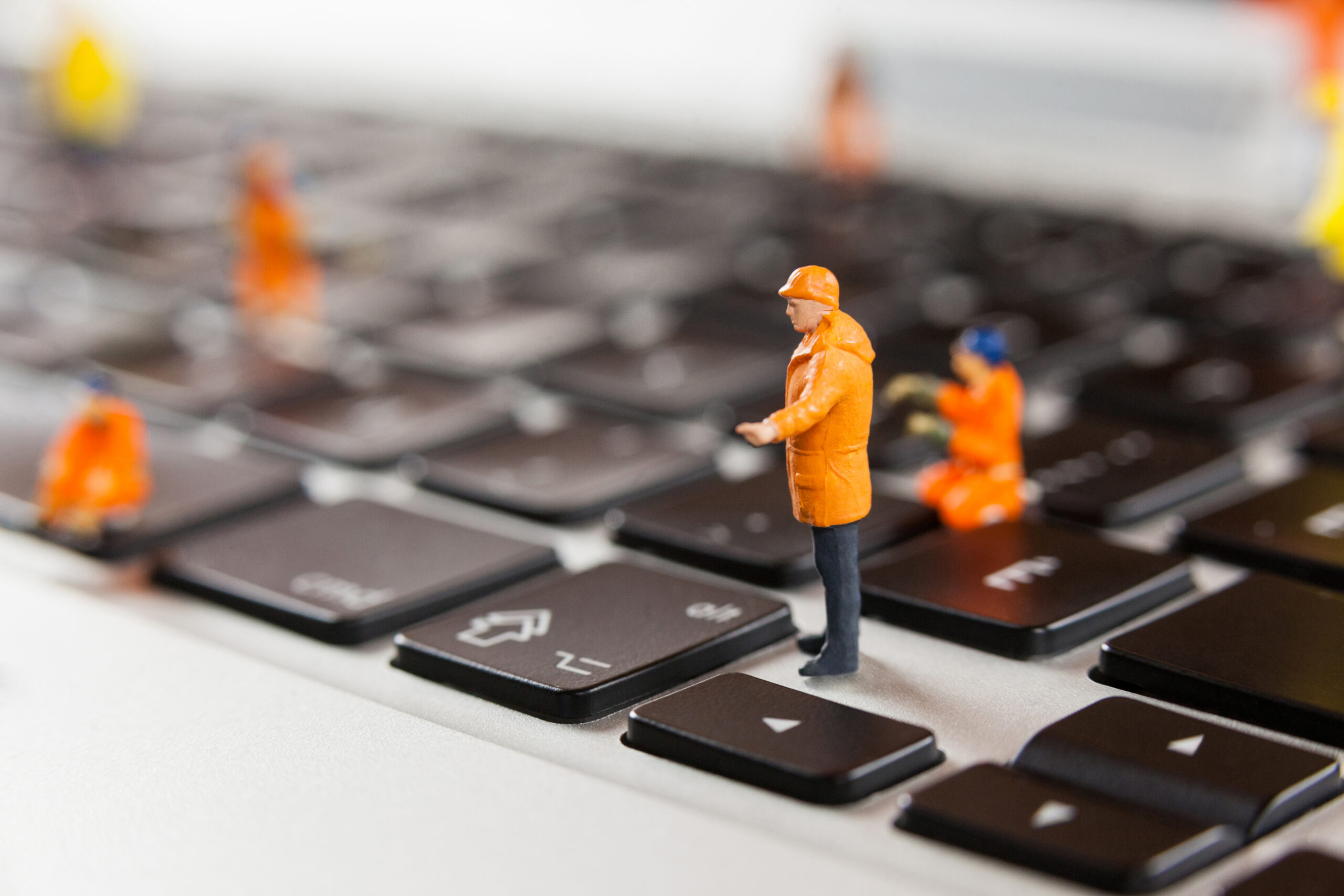 Little construction men on a keyboard representing fixing a website